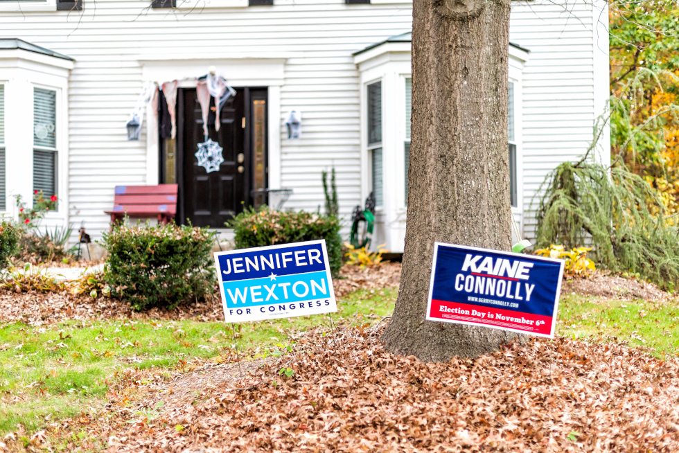 Herndon, USA - November 1, 2018: Political Election sign for Democrat Congress woman Jennifer Wexton representative on lawn, Tim Kaine, Connolly in Virginia, Halloween decorations